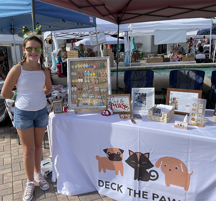 Image of Natalie Huntington of Deck the Paws selling handmade jewelry to raise funds to donate